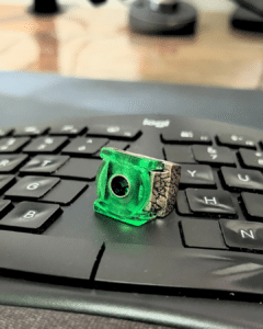 A green keycap with a camera icon on a keyboard.